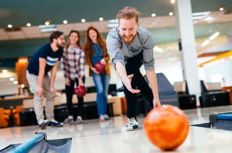 Friends bowling at a club