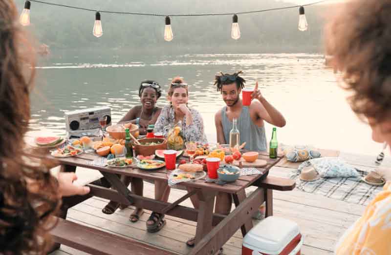 Friends having a picnic by the lake