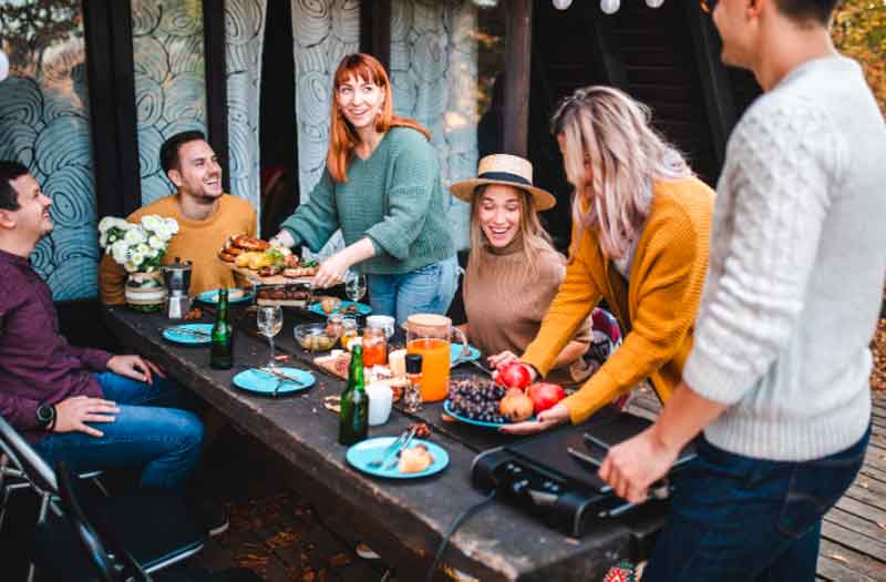 Friends setting up BBQ dinner