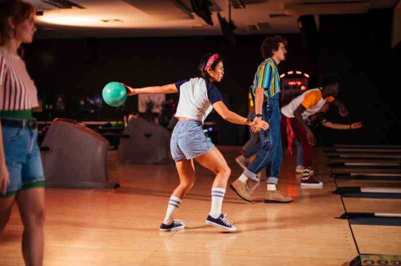 Girl playing at a bowling alley