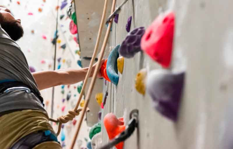 Man climbing rocks indoors