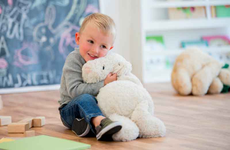 2-year-old hugging a stuffed animal