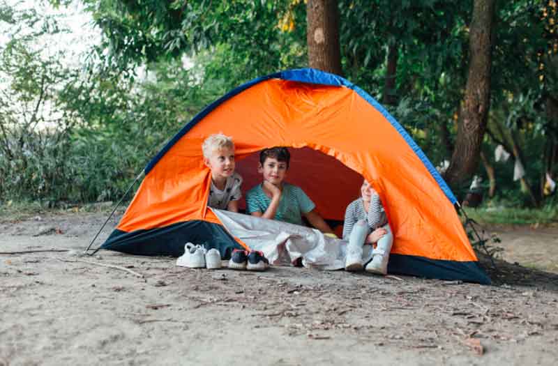 6-year-olds camping in a tent