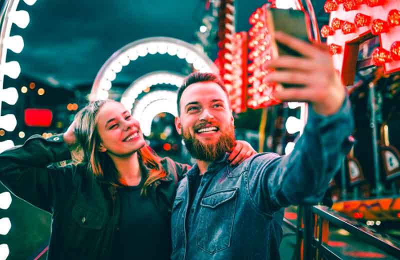 Couple taking photos at a theme park