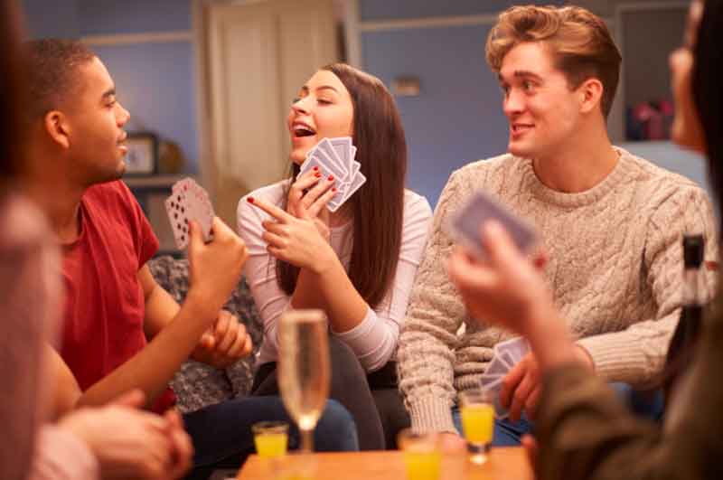 Friends playing card games at home