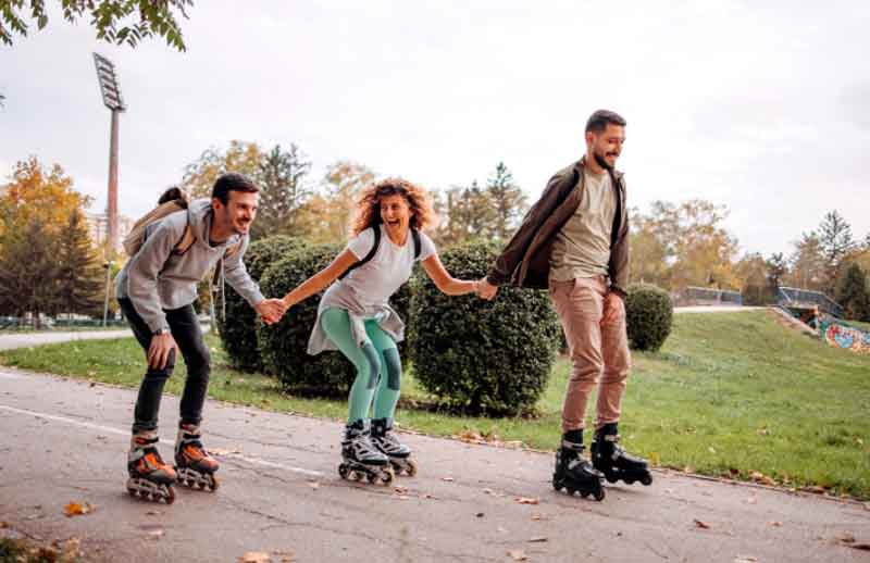 Friends rollerskating at a park