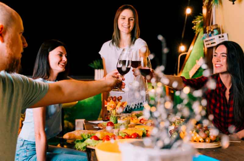 Friends tasting wine at home