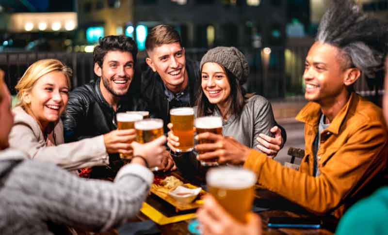 Friends toast with beer glasses