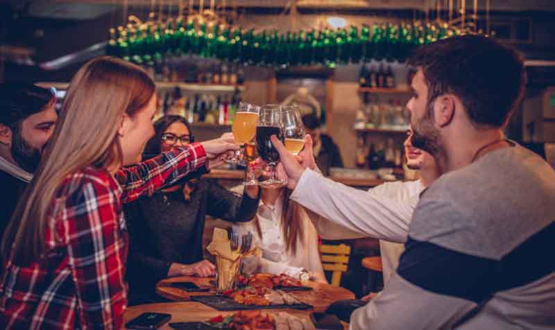 Friends toasting at the bar crawl