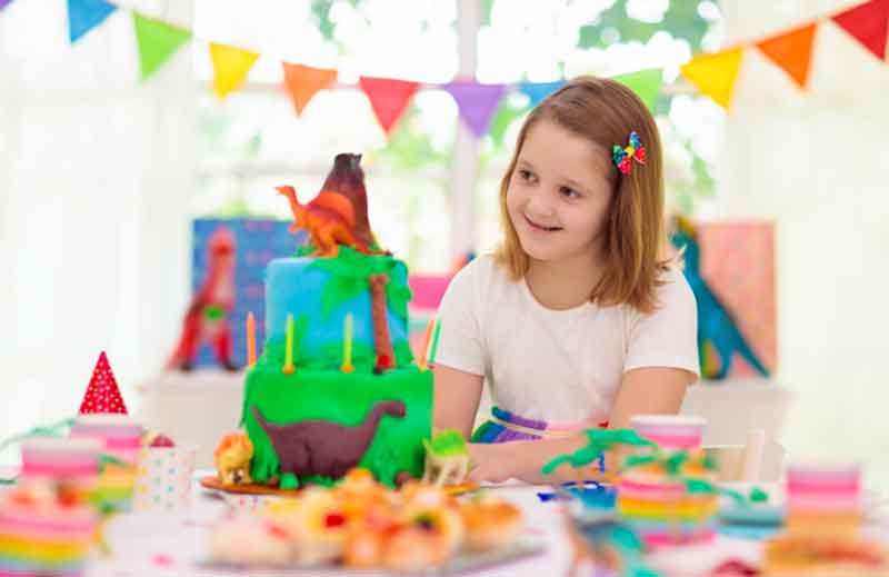 Girl playing with toy dinosaur