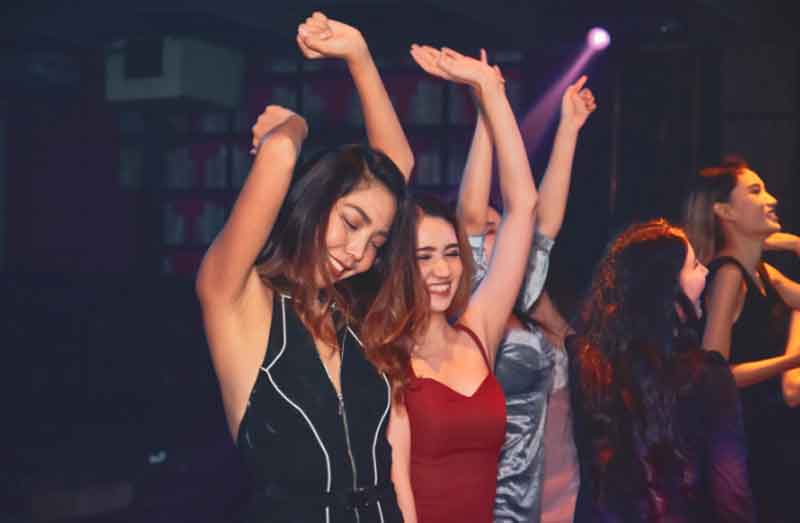 Girlfriends dancing at a party