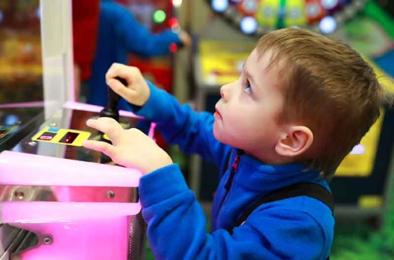 Kid at Chuck E. Cheese during his 4th birthday party