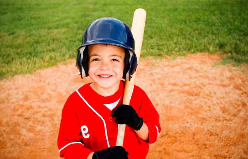 Kid smiling in baseball gear