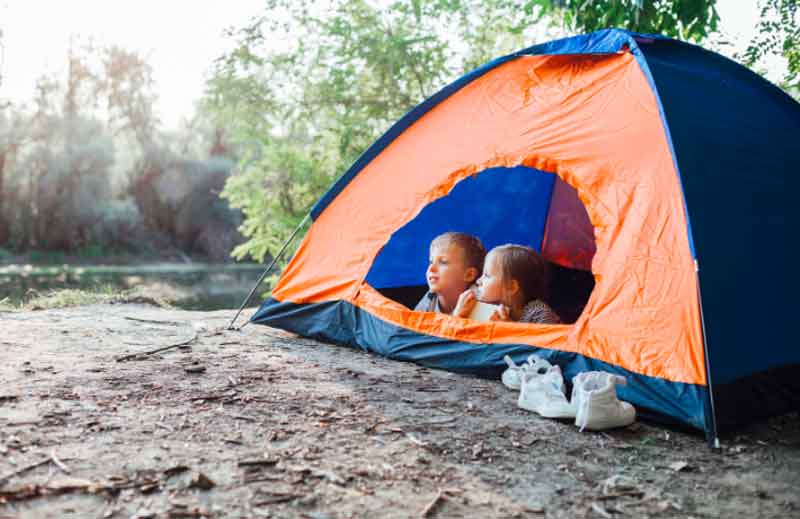 Kids camping outdoors in a tent