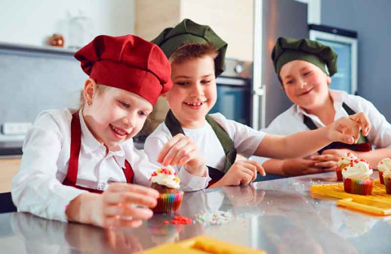 Kids decorating birthday cakes