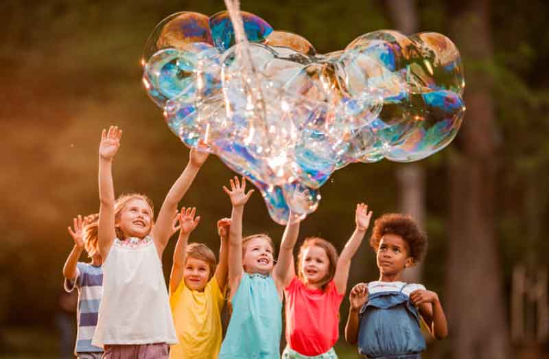 Kids playing with bubbles at a birthday party