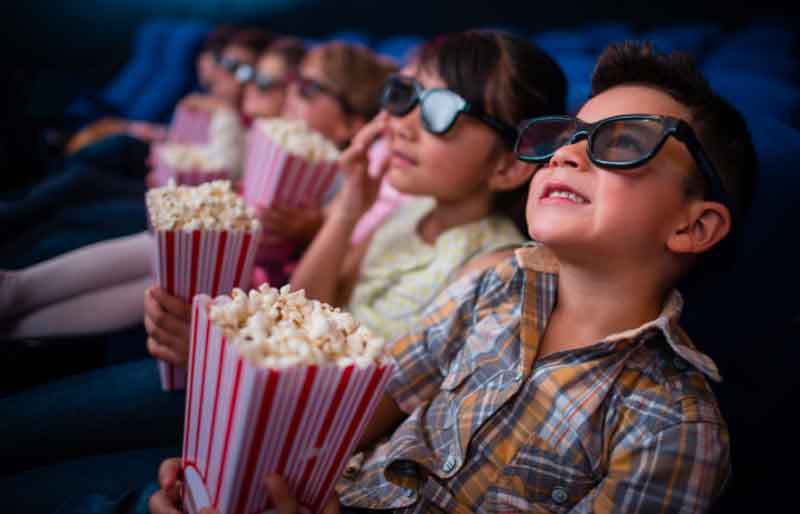 Kids watching a movie at a birthday party