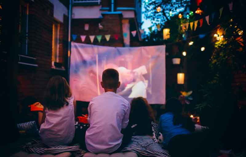 Kids watching a movie at a party