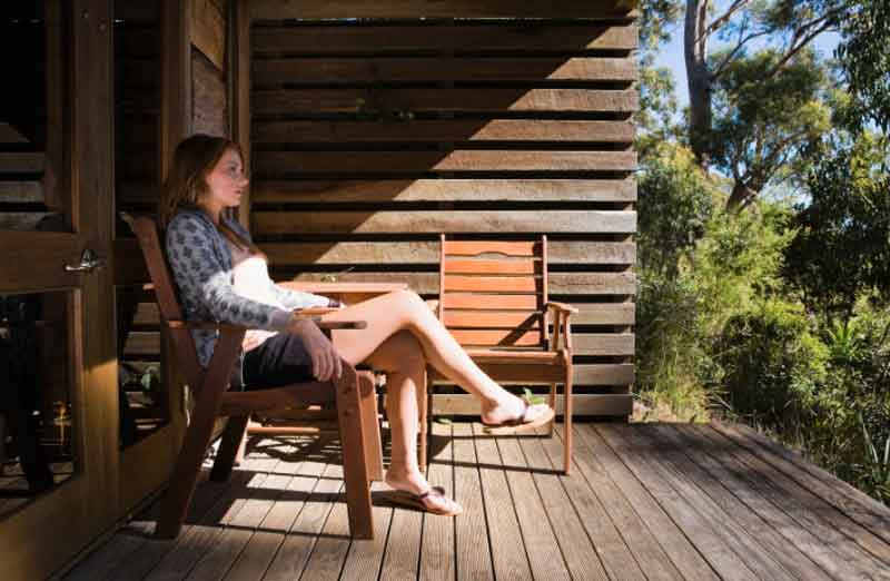 Woman enjoying a cabin in the woods