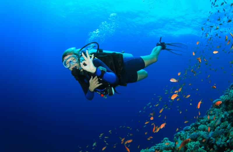 Woman scuba diving in the ocean
