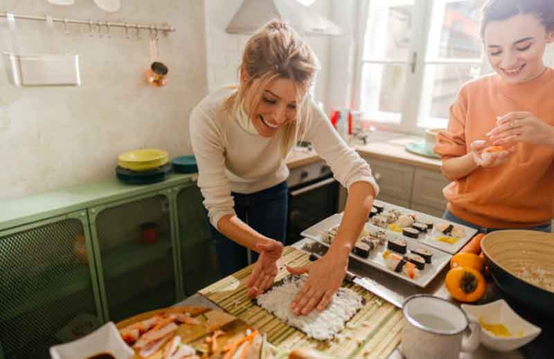 Women making sushi in the kitchen