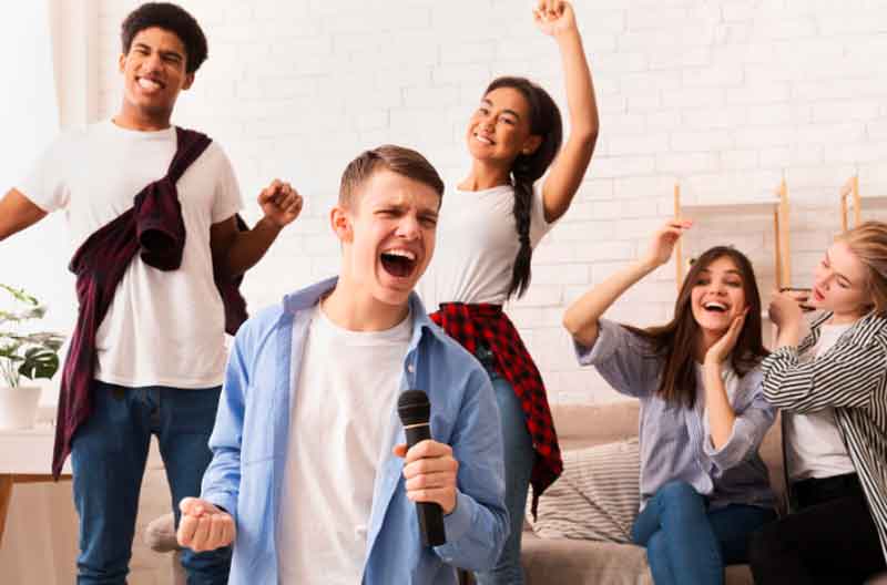 Boy singing at karaoke party