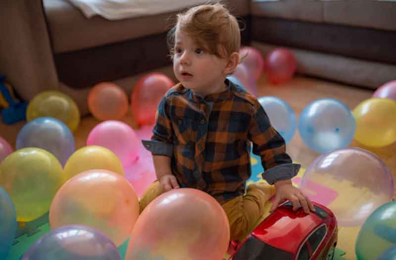 Child playing with balloons