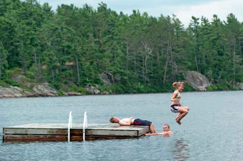 Girl jumping into a lake