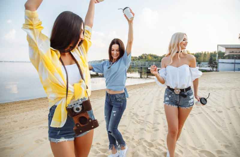 Teenage girls dancing on the beach