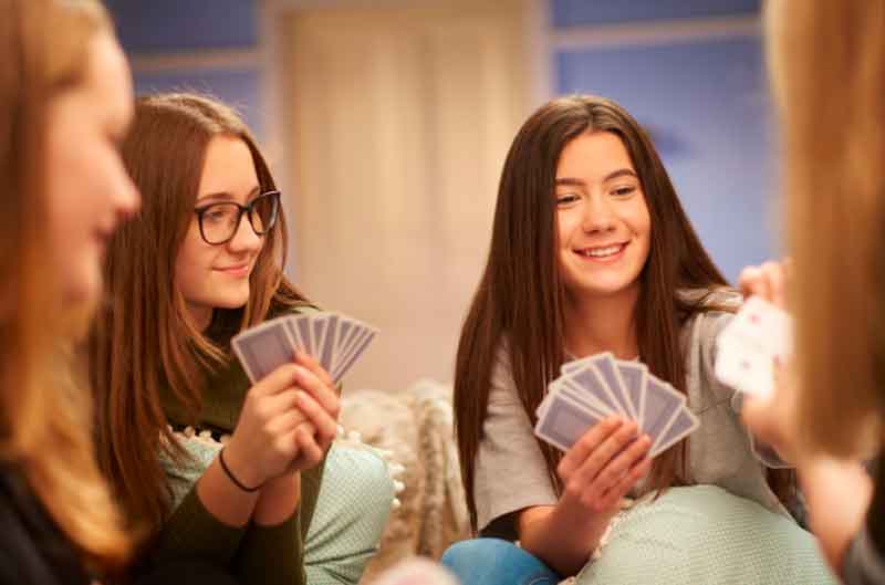Teenage girls playing card games
