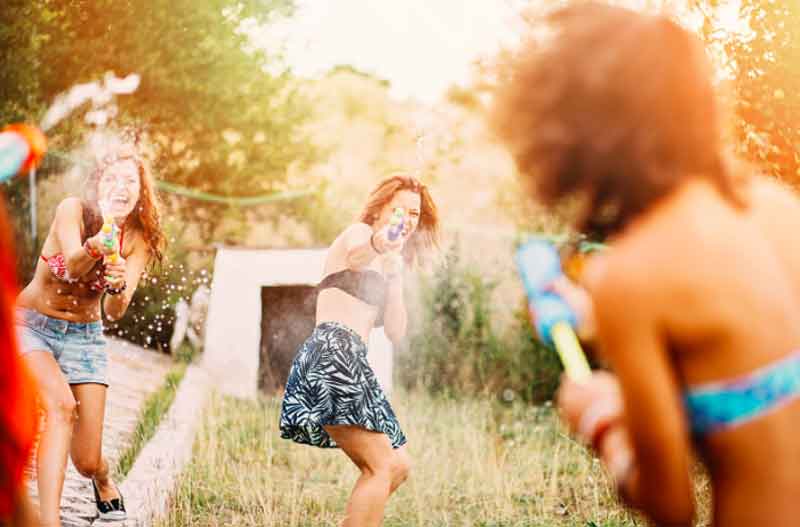 Teenagers in a water battle